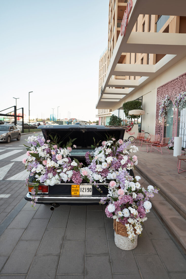 Flower Corner's classic wedding car dressed with fresh flowers