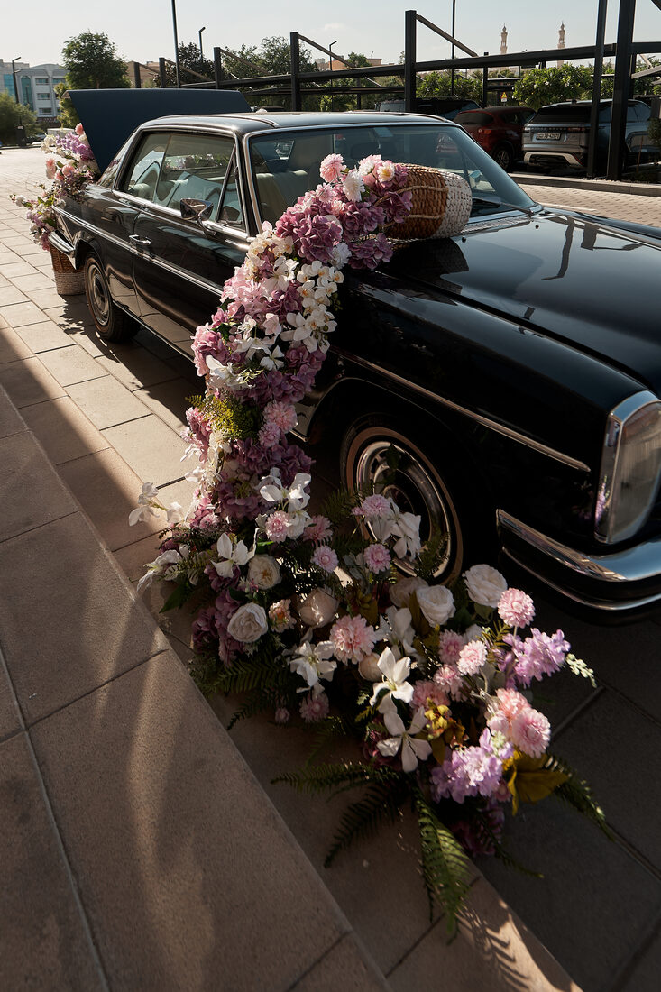 Flower Corner's classic wedding car dressed with fresh flowers
