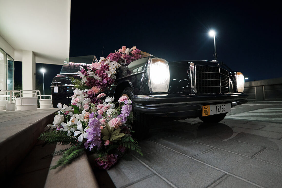 Flower Corner's classic wedding car dressed with fresh flowers